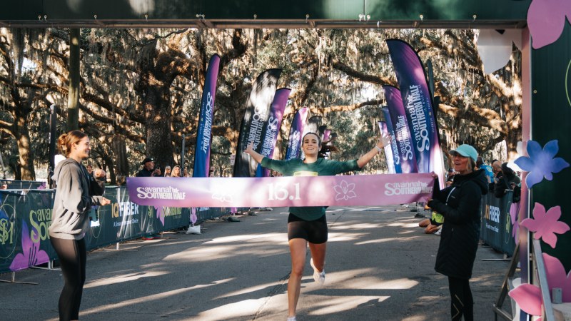 A runner breaking the tape at the finish line